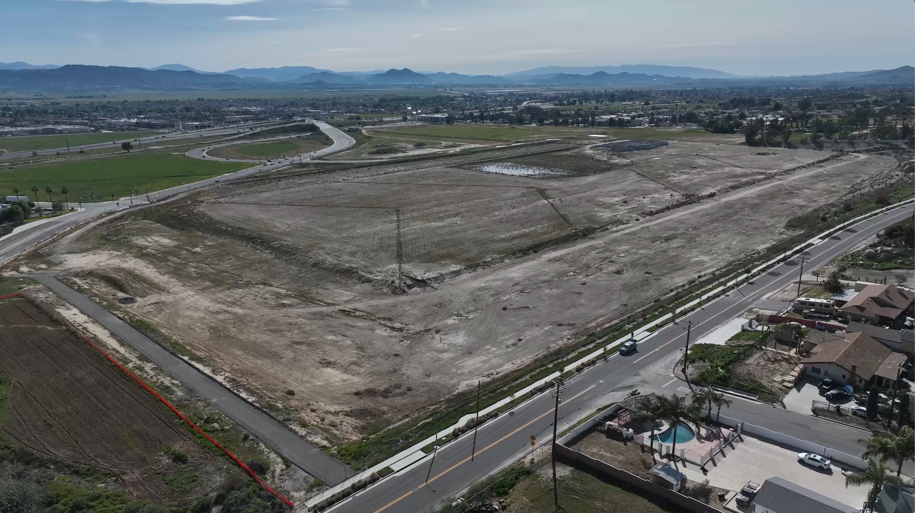 construction site shot from above with freeway in frame construction site shot from above with freeway in frame