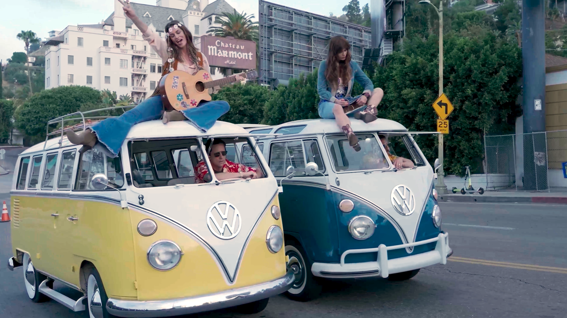two VW vans with women on top two VW vans with women on top