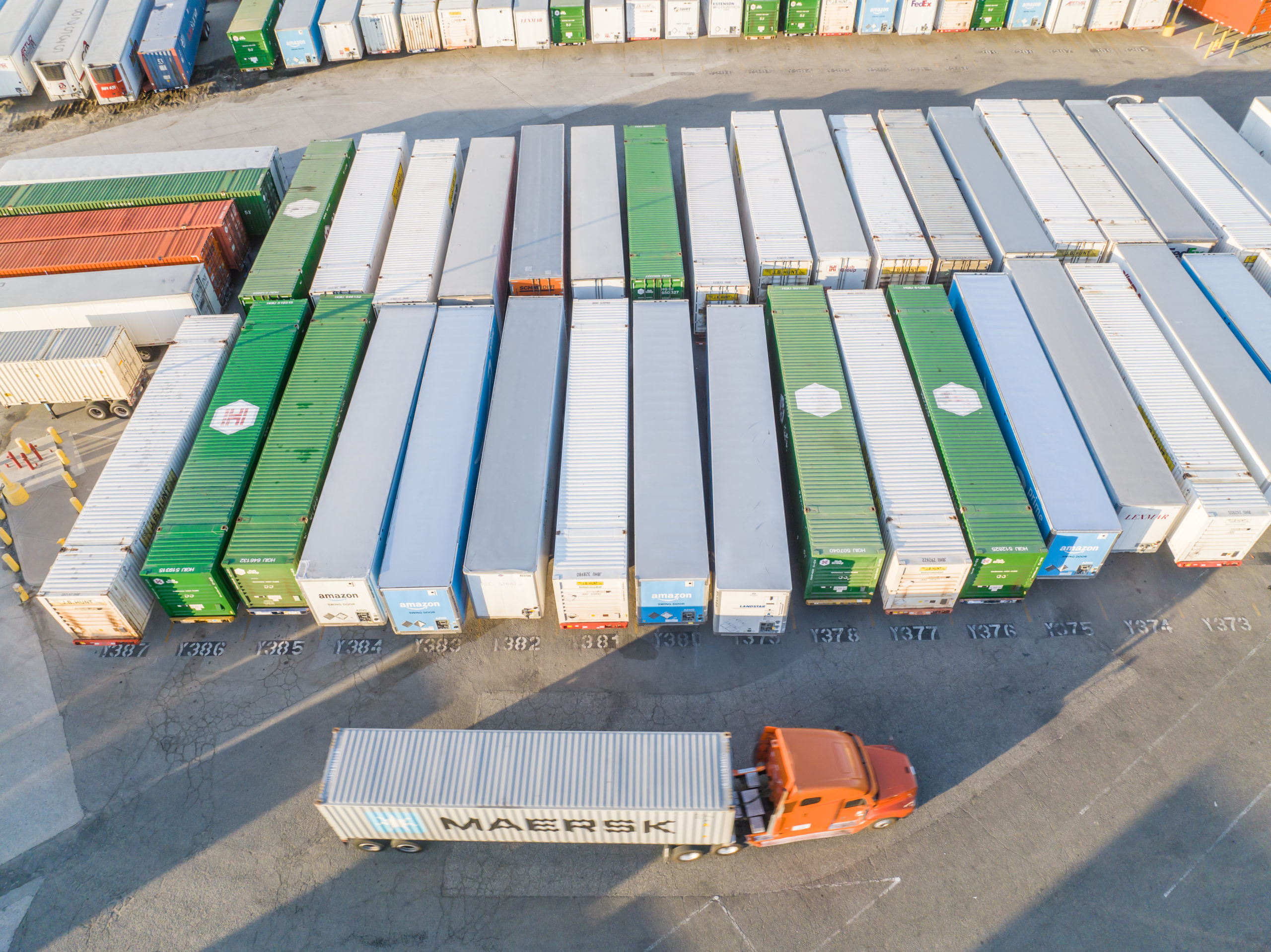 At 12:30 p.m. on August 31, 2022, an employee was picking up an empty shipping container while working as a truck driver. The employee received a list of empty containers from a dispatcher at arrived at a facility to locate and pick up the assigned empty container. The employee exited his truck to inspect an empty container at his employer's warehousing facility. While inspecting the container, an other truck driver who was an independent contractor was backing up to park a shipping container on an empty spot. The truck driver who was backing up had an obstructed view due to the shipping container, and he struck the container adjacent to where the employee was standing. As a result, the employee was pinned between two shipping containers and was killed by crushing injuries.